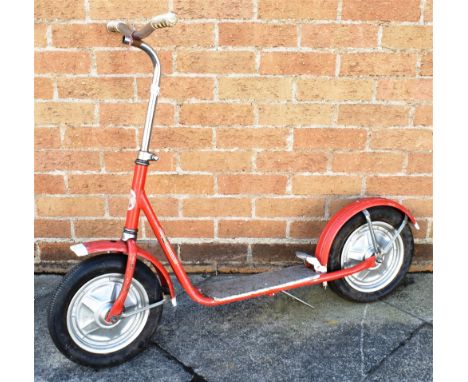 AN MW CHILD'S SCOOTER  circa 1960s, red, with a rear wheel brake and folding stand, overall 112cm long.