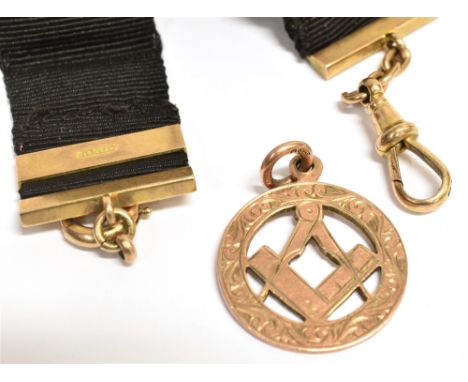 A 9CT ROSE GOLD MASONIC PENDANT PIECE Of open work design featuring the square and compass symbol, hallmarked for Birmingham 