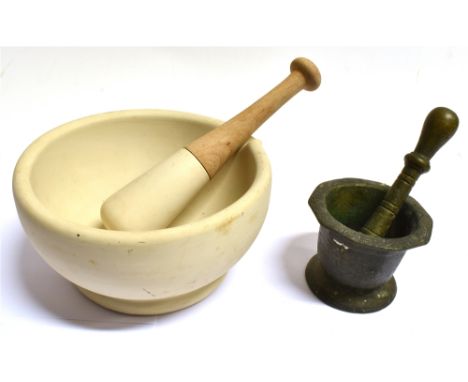 A BRONZE PESTLE AND MORTAR  the mortar 11.5cm diameter, together with a ceramic mortar and pestle with beechwood handle 23cm 