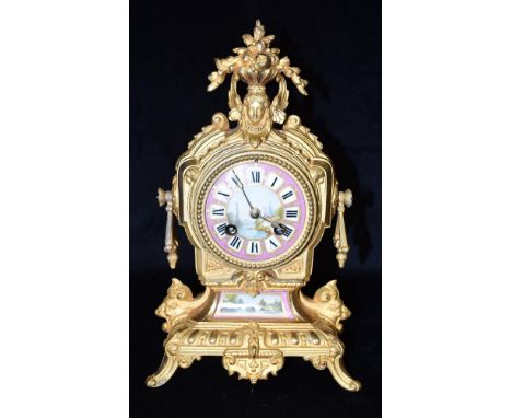 A 19TH CENTURY MANTLE CLOCK IN ROCOCO STYLE GILT METAL CASE  the 8-day movement striking on a bell, with Sevres style dial an