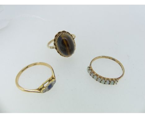 A 9ct yellow gold Ring, set with an oval cabochon tiger's eye, Size R, together with a very small art deco sapphire and diamo