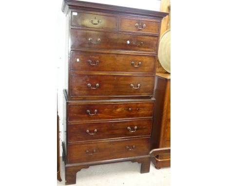 A Georgian mahogany Chest-on-Chest, the moulded cornice above two short and three long graduated drawers with brass handles, 