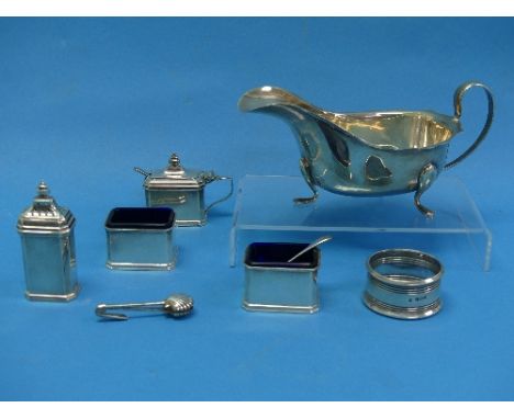 A George V silver four piece Cruet Set, by alker &amp; Hall, hallmarked Birmingham, 1927, of rectangular form with canted cor