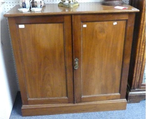 A Victorian mahogany two door Cupboard by Robson &amp; Sons, Newcastle on Tyne, the doors opening to reveal two slatted shelv