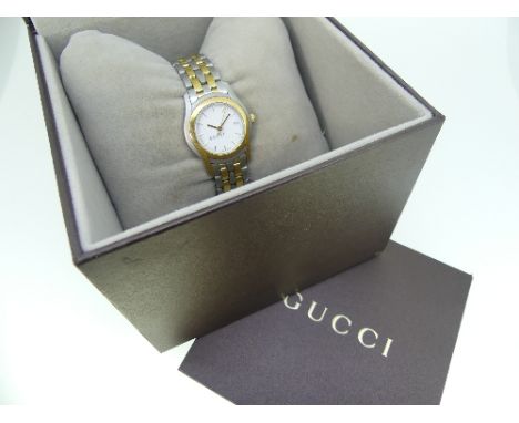 A Gucci 5500L stainless steel and gold plated lady's bracelet Wristwatch, quartz movement, the white dial with gilt baton mar