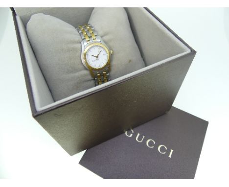 A Gucci 5500L stainless steel and gold plated lady's bracelet Wristwatch, quartz movement, the white dial with gilt baton mar