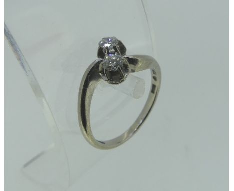 An 18ct white gold Ring, set on the cross with two small diamonds, Swedish hallmarks, Size J, approx total weight 3.3g.