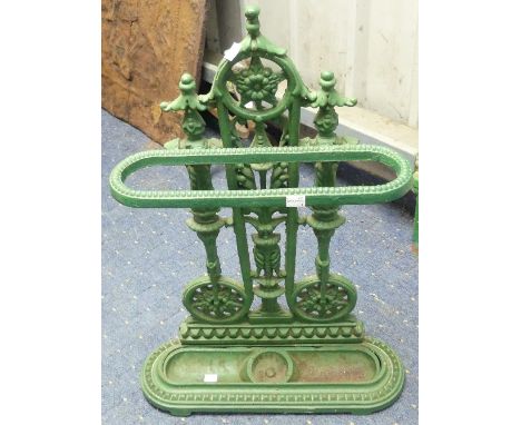 A green painted cast-iron Stick Stand, with decorative pierced back, rounded ends and inset drip pan, 19in (48cm) wide x 27in