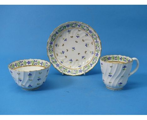 A Worcester Tea Trio, c. 1815, comprising a Tea Bowl, Tea Cup and Saucer, decorated with foliate design in gilt and blue, all
