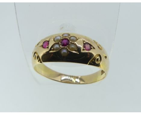 A 15ct yellow gold Ring, the front set with rubies and seed pearls forming a flowerhead, Size P, approx total weight 2.6g.