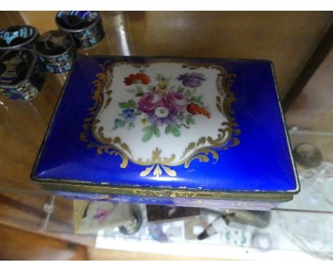 An antique Sevres floral hinged Box, the blue, floral and gilt decorations to the lid, the metal clasp to the front enabling 