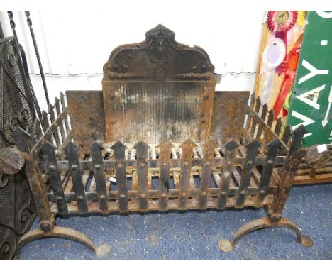 An antique cast iron Fire Grate, the Fire-Back panel with scrolled edge, above an open Fire Basket grate, of rectangular form