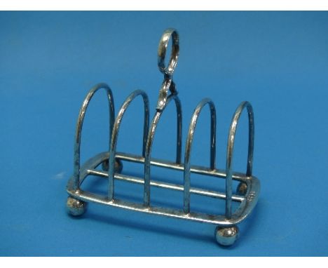 An Edwardian silver five bar Toast Rack, by Thomas Bradbury &amp; Sons Ltd., hallmarked Sheffield, 1902, of hoop form with ce