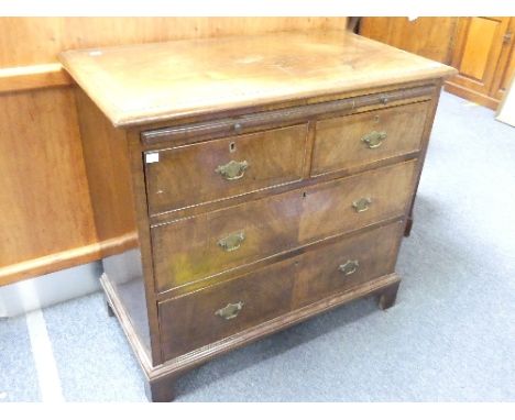 An early 20thC Georgian-style walnut Chest of Drawers, with a quarter-veneered top flanked by feather banding then cross band