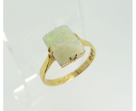 A Victorian opal Ring, the rectangular opal in four claw setting, chip to one corner, all in 18ct yellow gold, Size O.