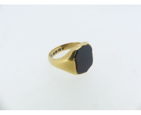 An 18ct yellow gold Signet Ring, the flared front set with a plain shield shaped bloodstone, Size R.