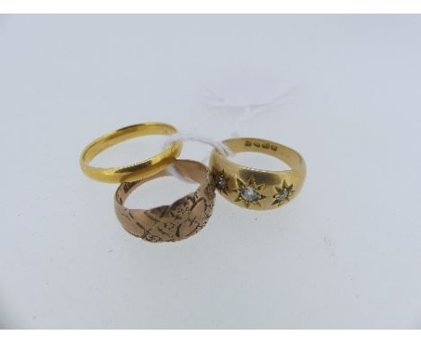 An 18ct yellow gold Ring, gypsy set with three graduated diamonds, 6.8g, together with a yellow gold band, marks rubbed, test