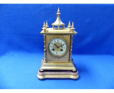 A late 19th century French Samuel Marti gilt-brass Mantel Clock, the case with foliate engraved decoration, pilasters, finial