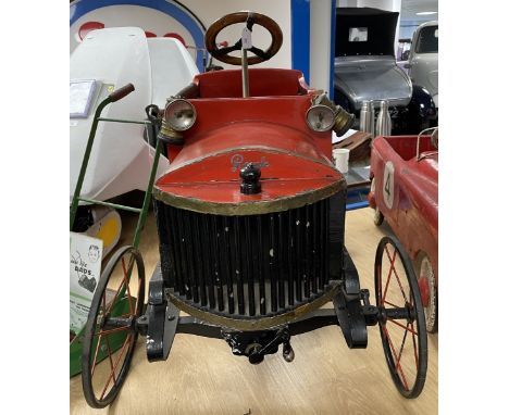An early Tri-ang child's pedal car, with a wooden body, a steel chassis, a metal 'crank' handle, wood rimmed steering wheel, 