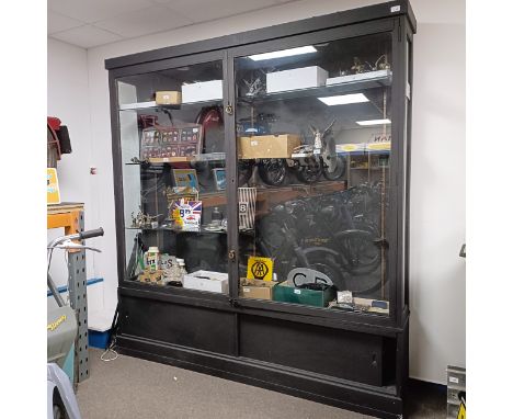A black painted display cabinet, lacks a glass shelf, 185.5 cm wide x 31 cm deep x 195 cm high  Please see our terms and cond