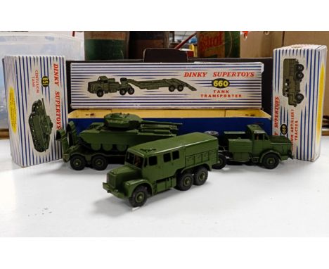 Three Dinky Supertoys military vehicles: a Tank Transporter, No 660, a Centurion Tank, No 651, and a Medium Artillery Tractor