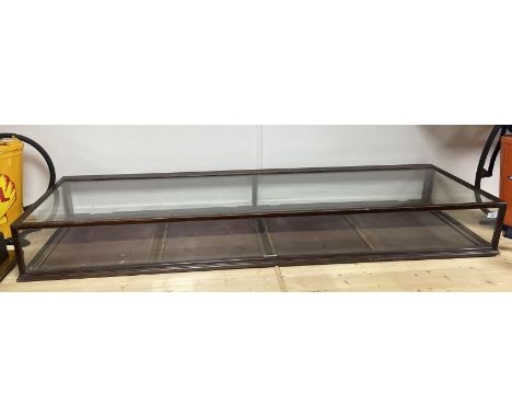 An early 20th century shop table top display cabinet, lacks doors, 179 cm wide  Please see our terms and conditions in relati