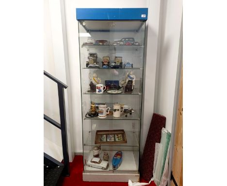 A glass display cabinet, 66 cm wde x 47 cm deep x 184 cm high, no lock  Please see our terms and conditions in relation to co
