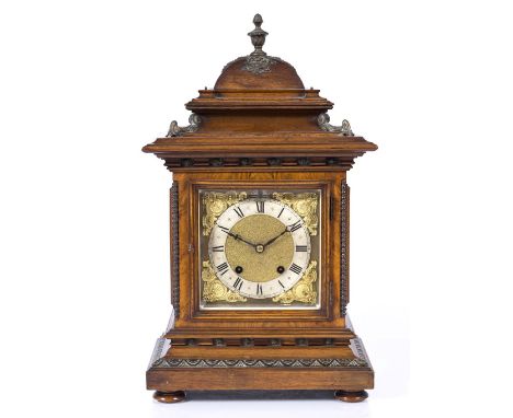 An Edwardian oak cased mantel clock with two train movement, gilded dial and relief decoration