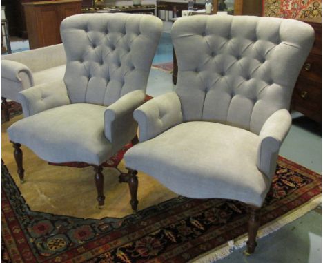ARMCHAIRS, a pair, Victorian style with a buttoned back and sides and light oatmeal upholstery on short turned front supports