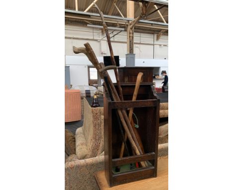 An early 20th century oak stickstand, with green enamel drip tray, containing a quantity of sticks and turned wood skittle, 3