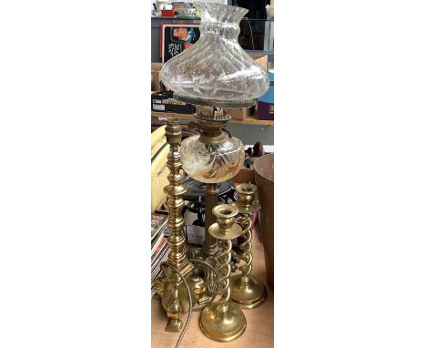 A brass oil lamp with fluted reeded column, glass reservoir and shade, 65cmH; a pair of double spiral brass candlesticks etc 