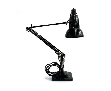 A black Herbert Terry anglepoise lamp on a stepped square base 