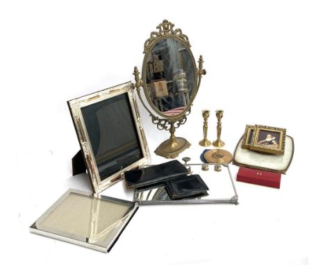 A pair of brass candlesticks, shaving mirror, various metal photo frames, compact, leather purse and wallet, empty Omega watc