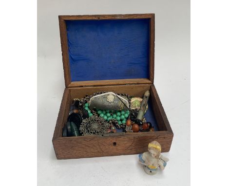 A carved wooden box containing a small amount of jewellery, to include a hallmarked 9ct gold cufflink (approx. 3.1g); white m