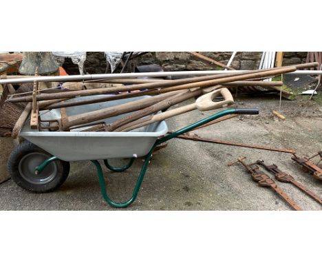 A galvanised wheelbarrow; together with a quantity of vintage garden tools, to include pickaxe, spades, forks, hoe, wooden ra
