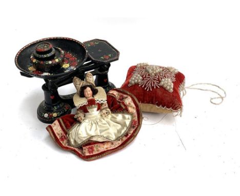 A set of painted kitchen scales, a faux pearl cushion and a doll 