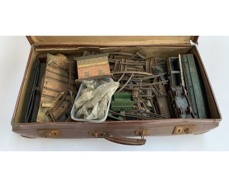 A suitcase containing a quantity of tin plate Hornby O gauge, including signal box and LNER wagon 