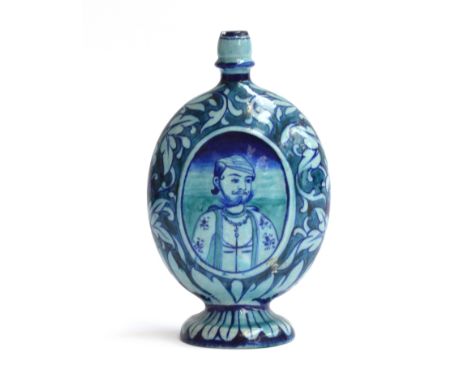 An Iznik bottle vase of compressed oval form, turquoise and blue glaze, with the central panel of each side decorated with a 