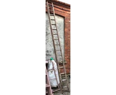 A two-section wooden ladder, each section 16 rungs 