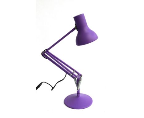 A modern purple anglepoise lamp 