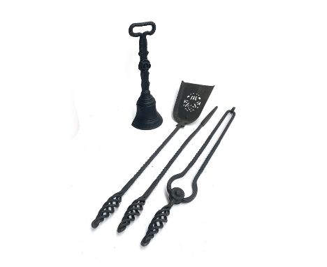 A cast iron doorstop together with a quantity of wrought iron fire tools 