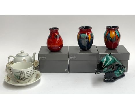 Three boxed Poole Pottery 'Volcano' miniature vases; together with a Wedgwood Peter Rabbit teacup and saucer; Doulton plate e