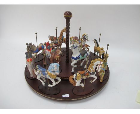 The Magic of the Merry-Go-Round, twelve carousel animal figures by Franklin Mint, with certificates and tiered wooden carouse