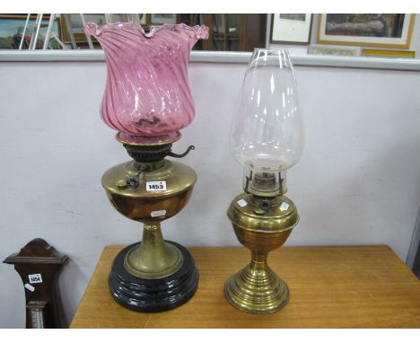 Two Oil Lamps; together with a XIX Century brass oil lamp, with a pink glass shade, one other lamp. (2)