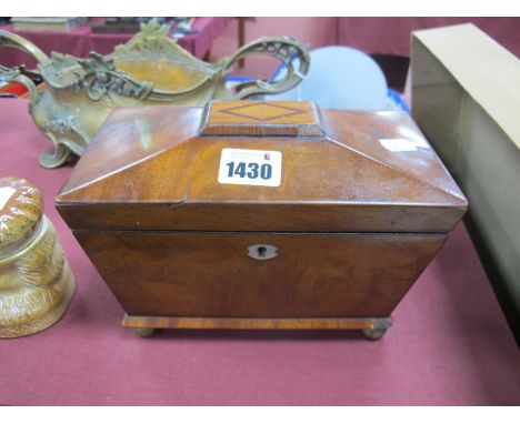 A XIX Century Mahogany Sarcophagus Tea Caddy, with lion brass ring handles, on gilded brass bun feet.