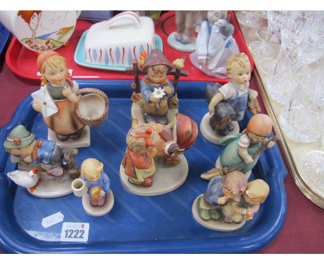 Hummel Figurines, including shoe seller, girl holding basket and envelope, pram. (8)