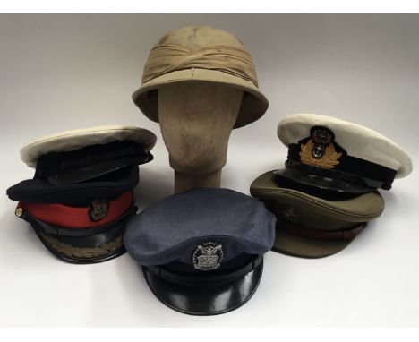 A selection of 20th century military headwear, to include: A WW2 era Intelligence Corps cap and badge, a 1945 dated South Afr
