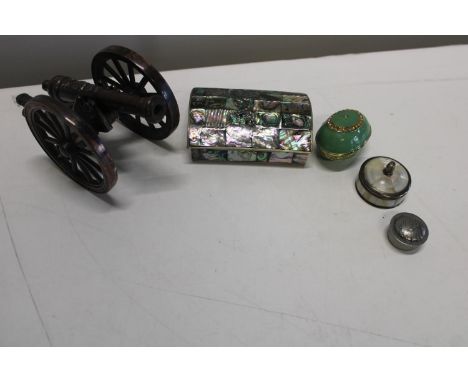 A cast metal model canon and selection of assorted trinket boxes 