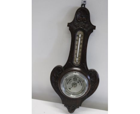 An antique oak cased barometer 