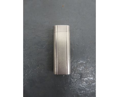 A Cartire cigarette lighterwith engine turned finish and flip top; inscribed Cartire Paris D84108 to the base; close inspecti